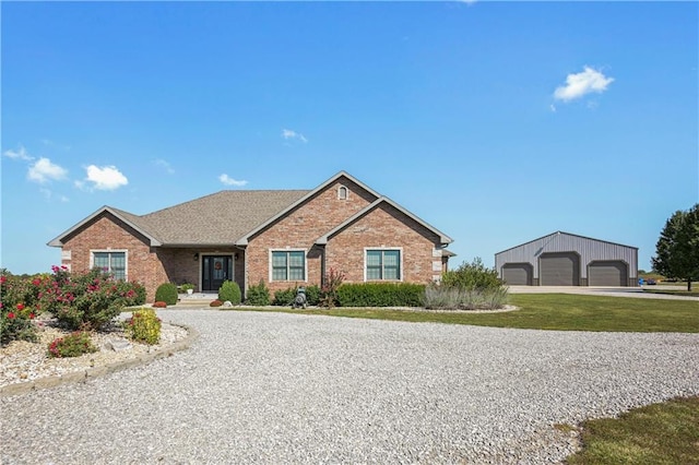 ranch-style house with a garage and an outbuilding