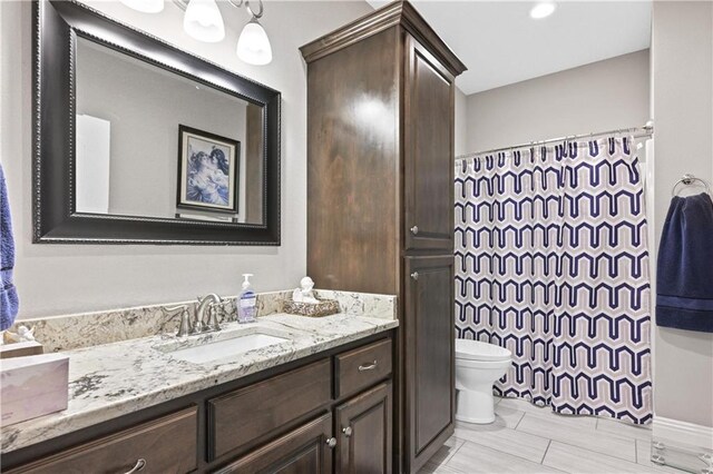 bathroom featuring toilet and vanity