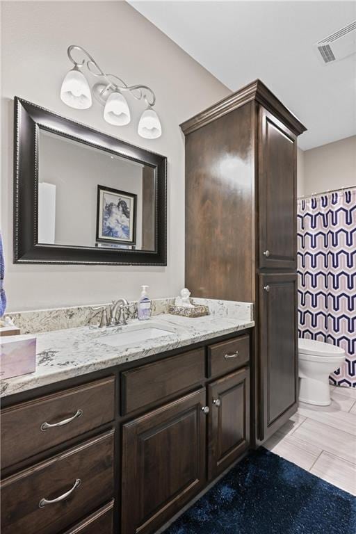 bathroom featuring vanity and toilet