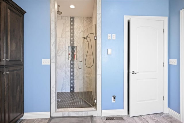 bathroom featuring an enclosed shower and hardwood / wood-style flooring