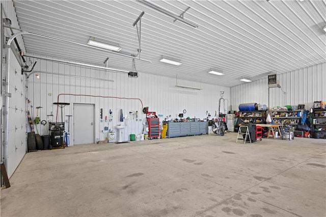 garage featuring a garage door opener and a workshop area