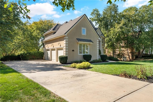 view of home's exterior featuring a garage and a yard