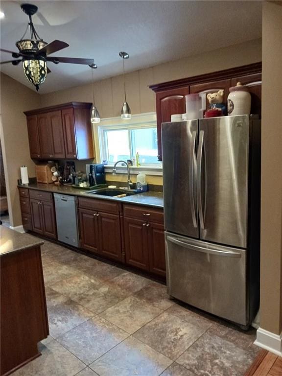 kitchen featuring ceiling fan, decorative light fixtures, appliances with stainless steel finishes, and sink