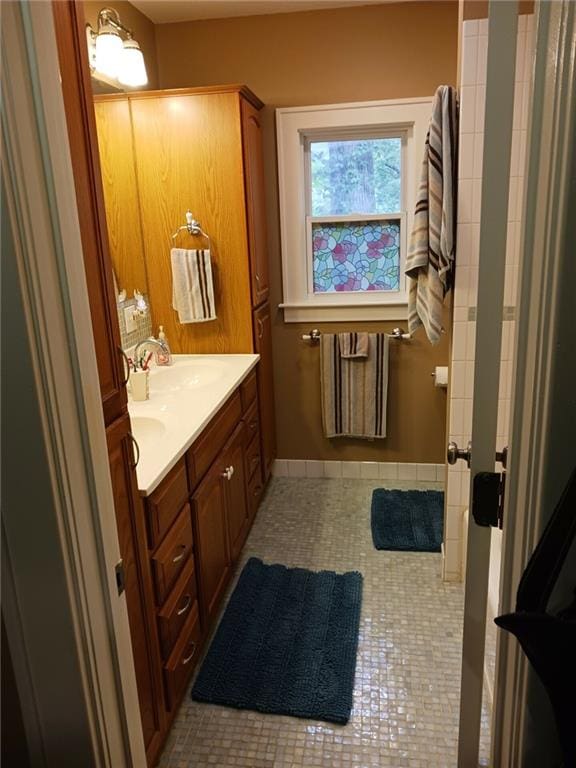 bathroom with tile patterned flooring and vanity