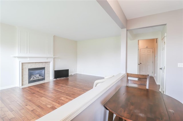 unfurnished living room with hardwood / wood-style floors and a fireplace