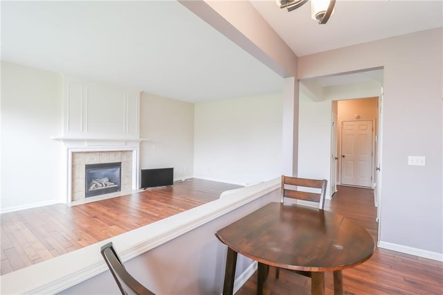 living room with dark hardwood / wood-style floors and a tile fireplace