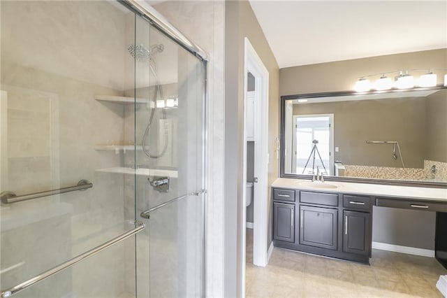 bathroom with walk in shower, vanity, and toilet