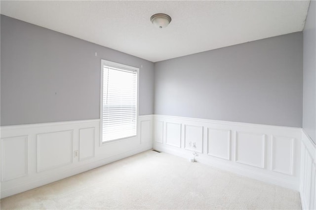 empty room featuring light colored carpet