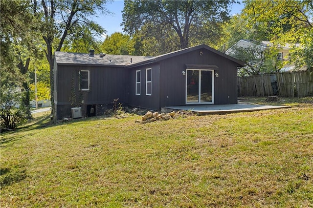 rear view of property featuring a yard and a patio area