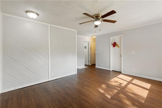 empty room with dark wood-type flooring, ceiling fan, crown molding, and a textured ceiling