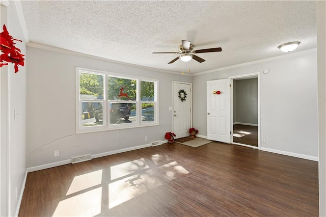 spare room featuring a textured ceiling, crown molding, ceiling fan, and dark hardwood / wood-style flooring