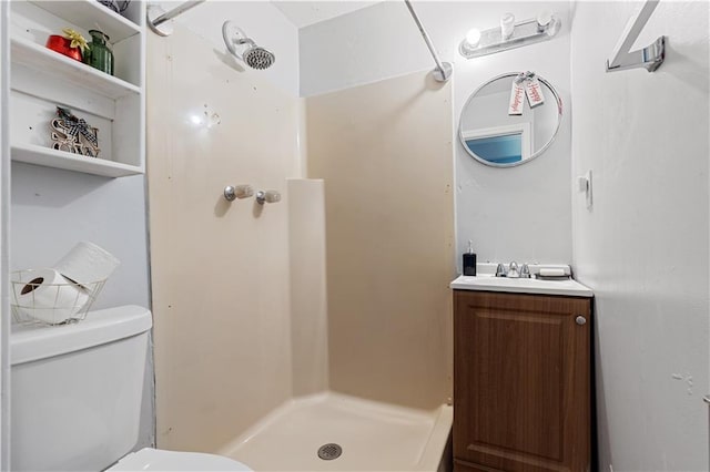 bathroom with walk in shower, vanity, and toilet