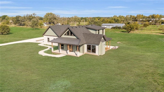 rear view of house with a yard and a patio