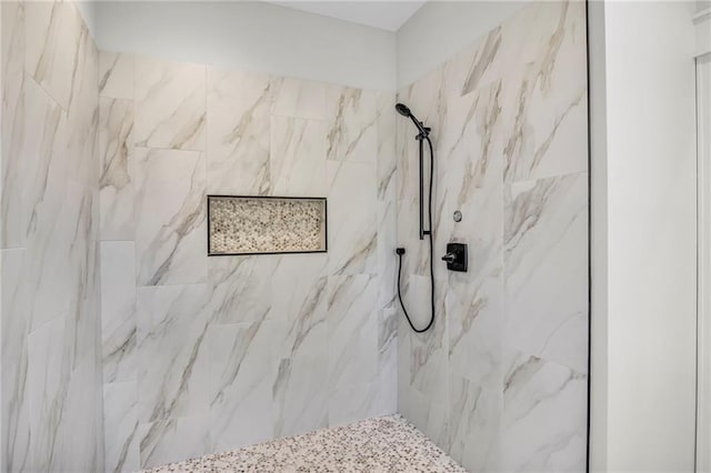 bathroom with a tile shower