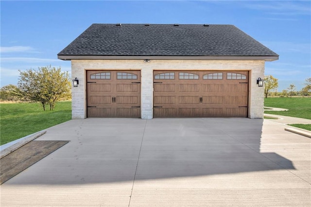 garage featuring a lawn