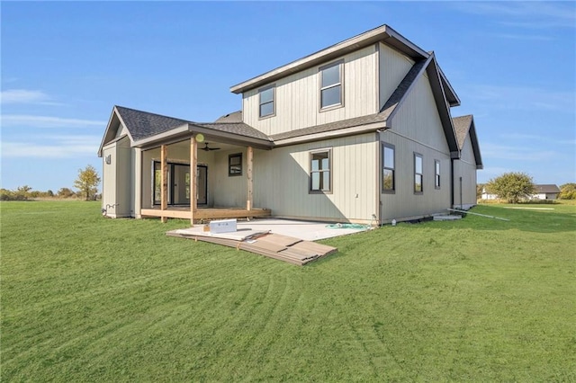 rear view of property featuring ceiling fan, a yard, and a patio