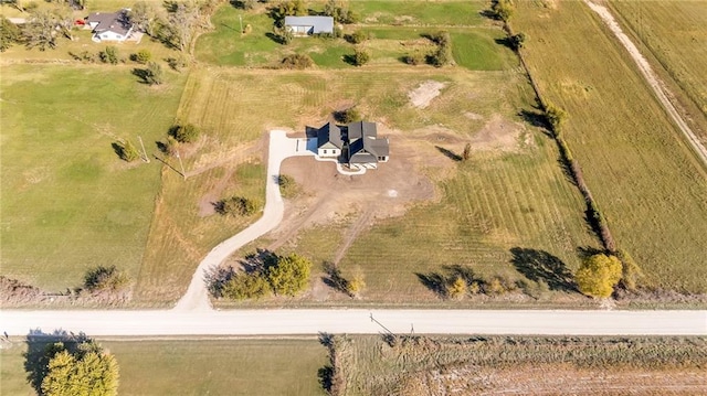 birds eye view of property with a rural view