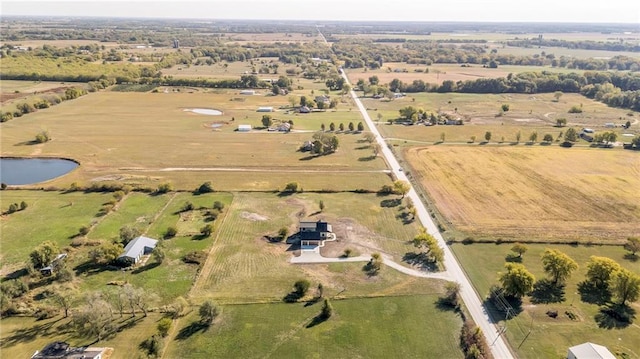 birds eye view of property featuring a rural view and a water view