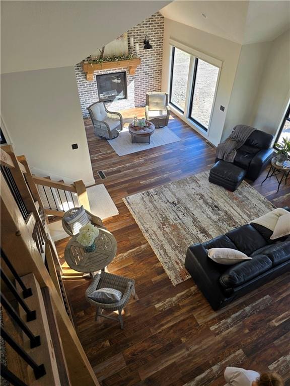 living room featuring lofted ceiling and dark wood-type flooring