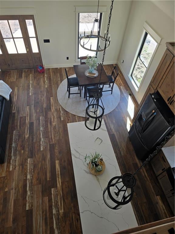 unfurnished dining area with dark hardwood / wood-style floors and a wealth of natural light