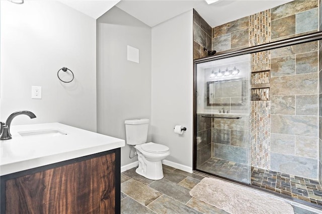 bathroom with vanity, toilet, and a shower with shower door