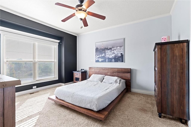 carpeted bedroom with crown molding and ceiling fan