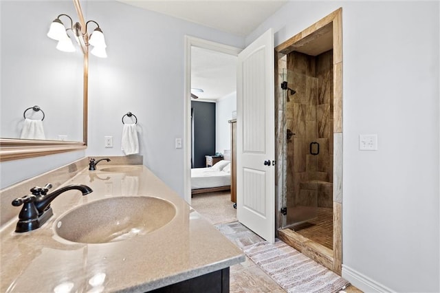 bathroom featuring a shower with door and vanity