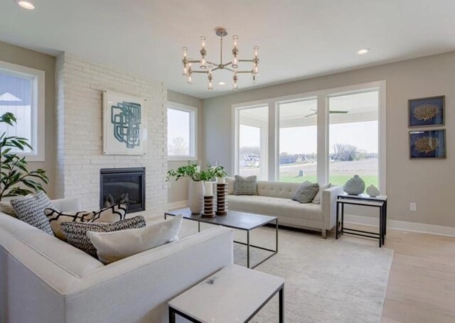 9300 Zarda Dr, Lenexa, KS 66227 - living room featuring recessed lighting, light wood-style flooring, baseboards, and a brick fireplace