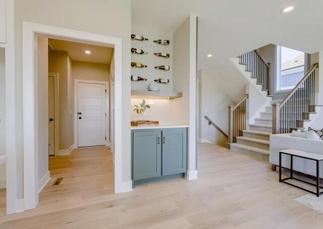 9300 Zarda Dr, Lenexa, KS 66227 - interior space featuring baseboards, stairway, light wood-style flooring, and recessed lighting