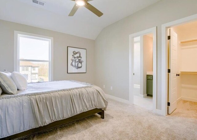 9300 Zarda Dr, Lenexa, KS 66227 - bedroom featuring lofted ceiling, visible vents, a walk in closet, and light carpet