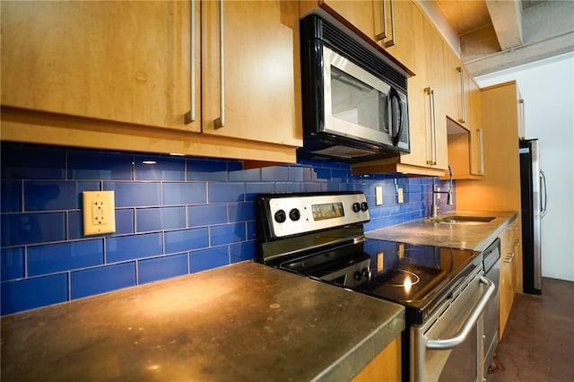 kitchen with backsplash, sink, and appliances with stainless steel finishes