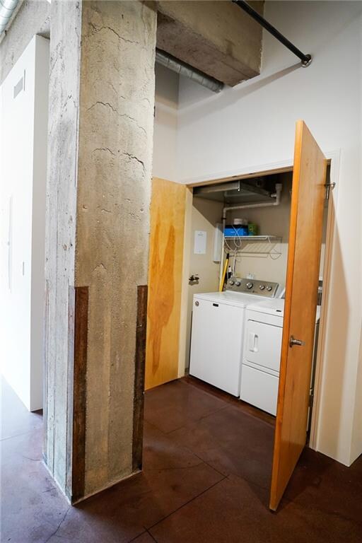 clothes washing area featuring washer and dryer