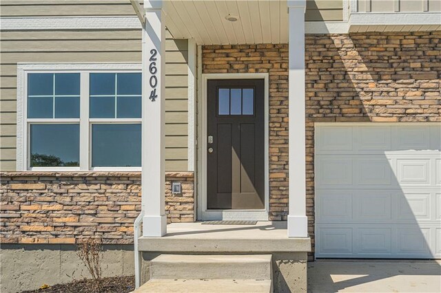 doorway to property featuring a garage