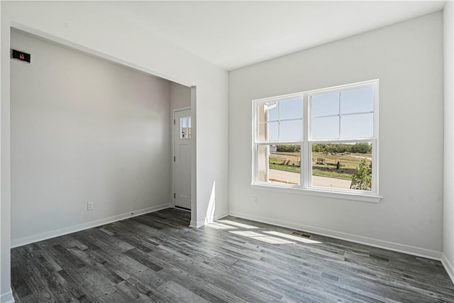 spare room with dark hardwood / wood-style flooring