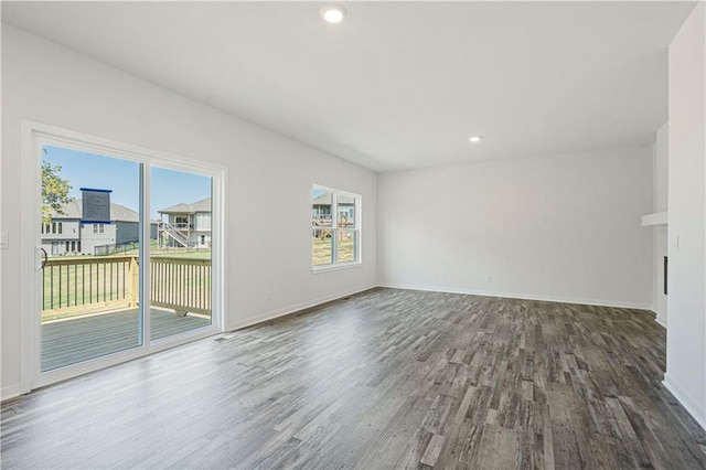 unfurnished room with dark wood-type flooring