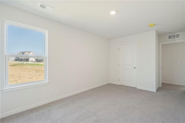 unfurnished bedroom featuring light colored carpet