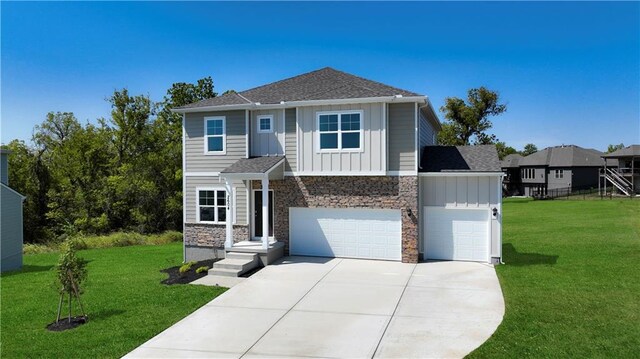 view of front of home with a garage and a front lawn