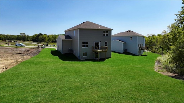 rear view of property with a lawn