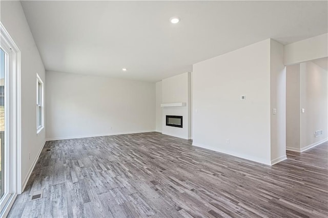 unfurnished living room with hardwood / wood-style flooring