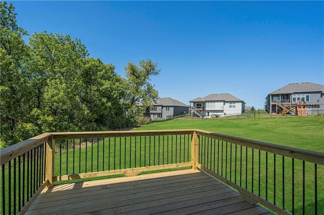 wooden deck featuring a lawn