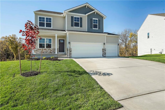 view of front of house featuring a garage and a front lawn