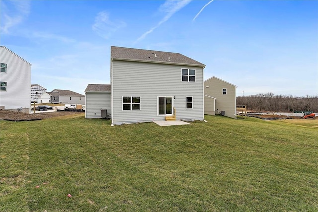 back of house featuring central AC and a lawn