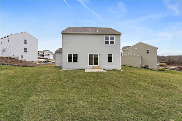 rear view of house with a patio and a lawn