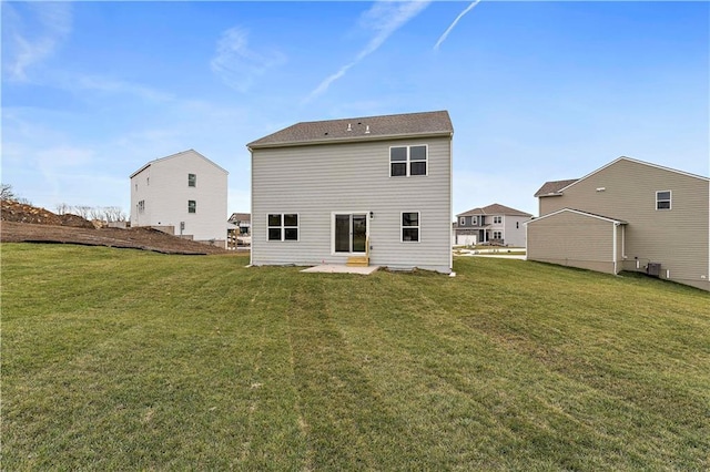 back of house featuring a yard, central AC unit, and a patio area