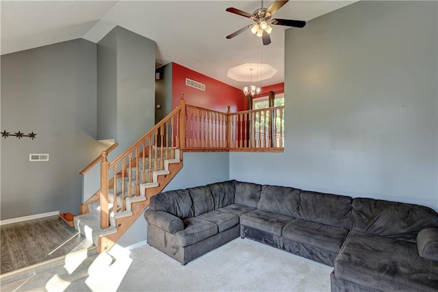 living room featuring hardwood / wood-style flooring, ceiling fan with notable chandelier, and lofted ceiling