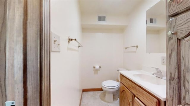 bathroom featuring vanity, tile patterned floors, and toilet