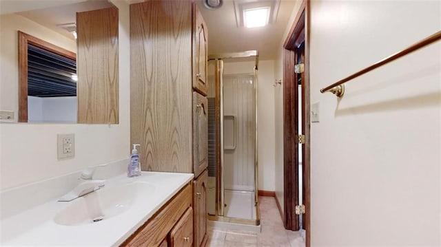 bathroom featuring vanity, an enclosed shower, and tile patterned floors