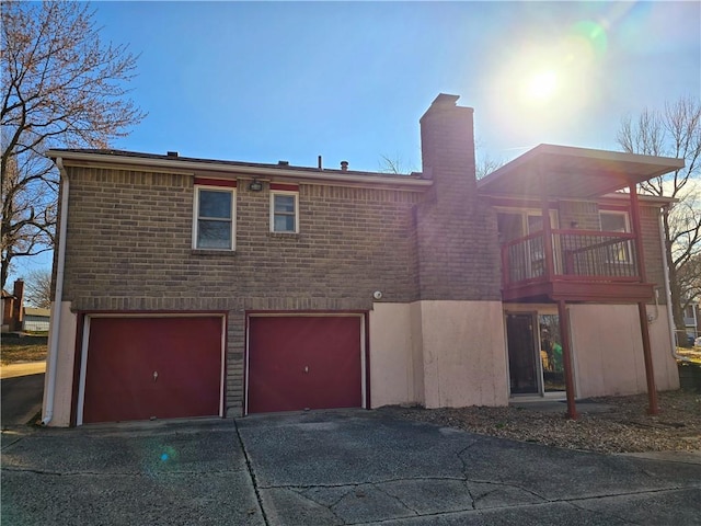 exterior space with a garage and a balcony