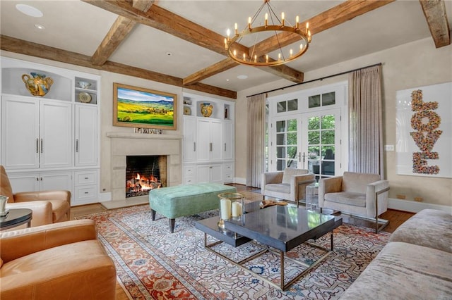 living room with french doors, beam ceiling, a notable chandelier, and wood-type flooring