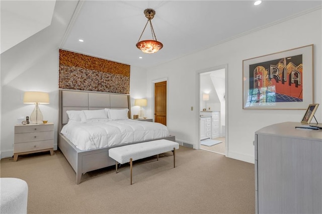 bedroom featuring ensuite bath and carpet flooring